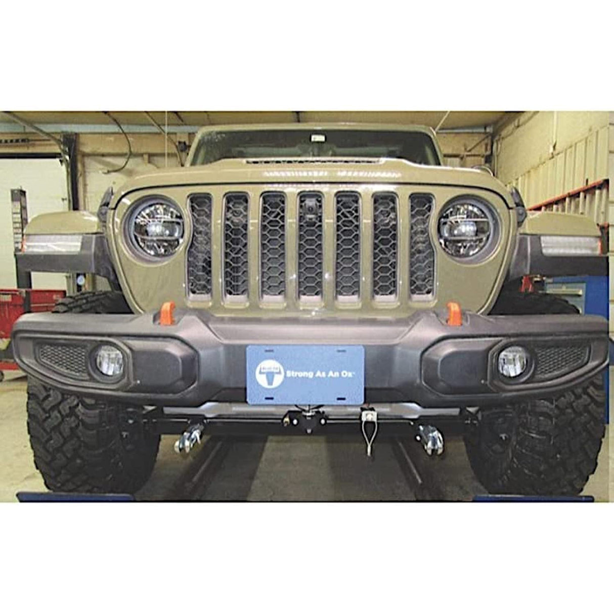 BX1145 Blue Ox Bumper Splitter for 2020-2021 Jeep Gladiator, front view installation in a garage, high-quality material, sleek protection enhancement.