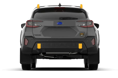 Rear view of a 2024 Subaru Crosstrek Wilderness with Rally Armor black UR mudflaps featuring a wild-orange logo, showcasing durable protection and no-drill installation.