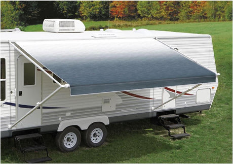 White 14' Carefree Fiesta awning attached to a travel trailer, providing shade and comfort in a grassy outdoor setting.