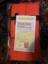 10000-02-A-OR Airhead Type II Keyhole Life Vest in orange packaging with safety information leaflet.